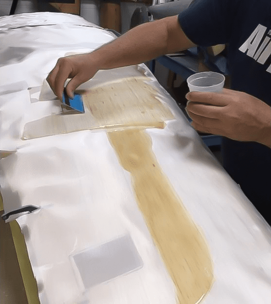 Applying fiberglass with resin